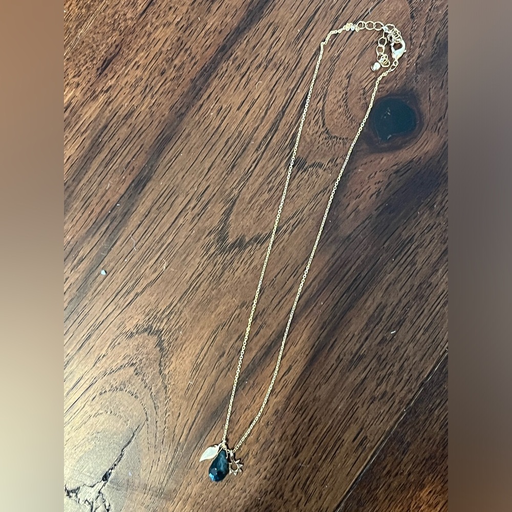 Gold necklace with cute little charms and green semi precious crystal